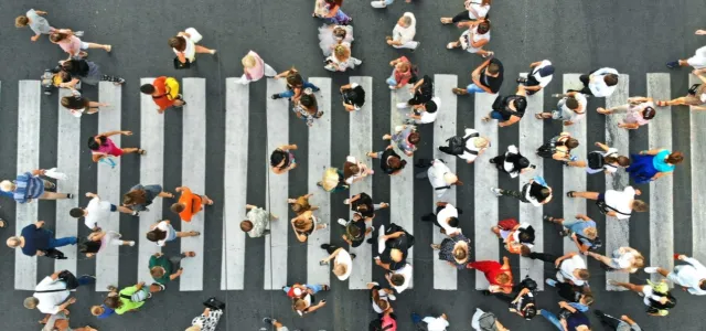 People crowd on pedestrian crosswalk